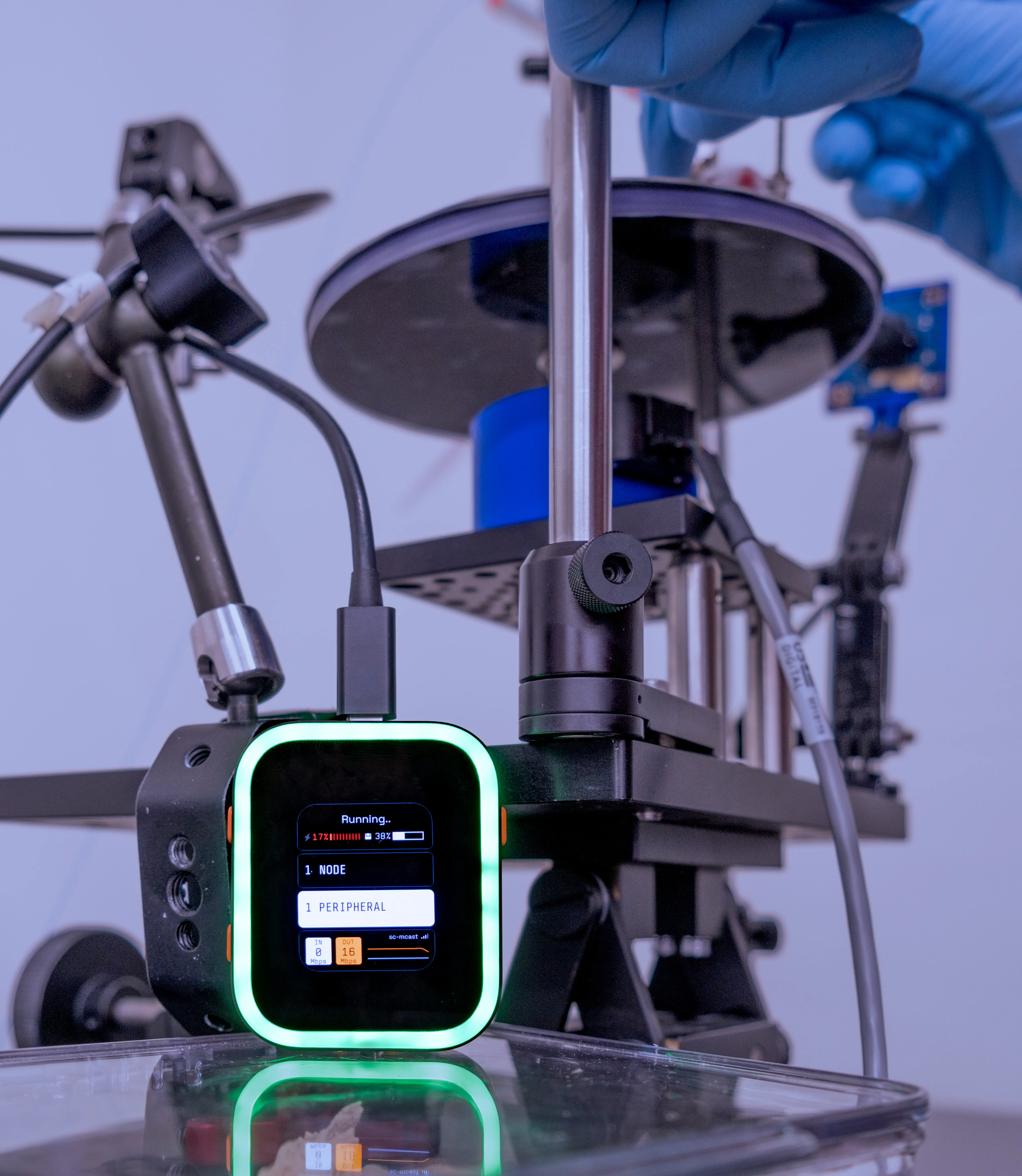 A SciFi headstage stands in front of an active behavior rig, connected to an implanted probe.
