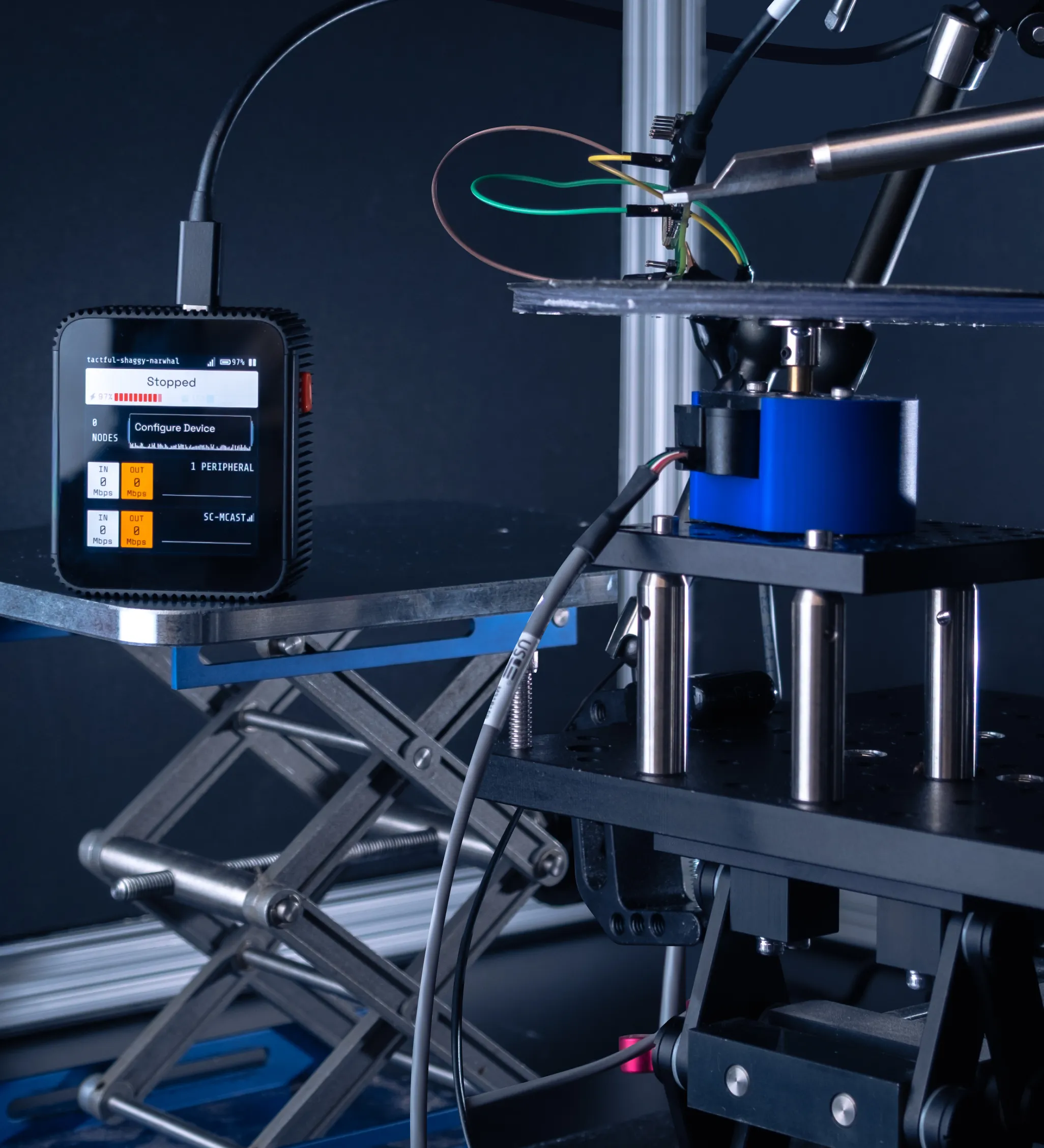 A SciFi headstage stands in front of an active behavior rig, connected to an implanted probe.
