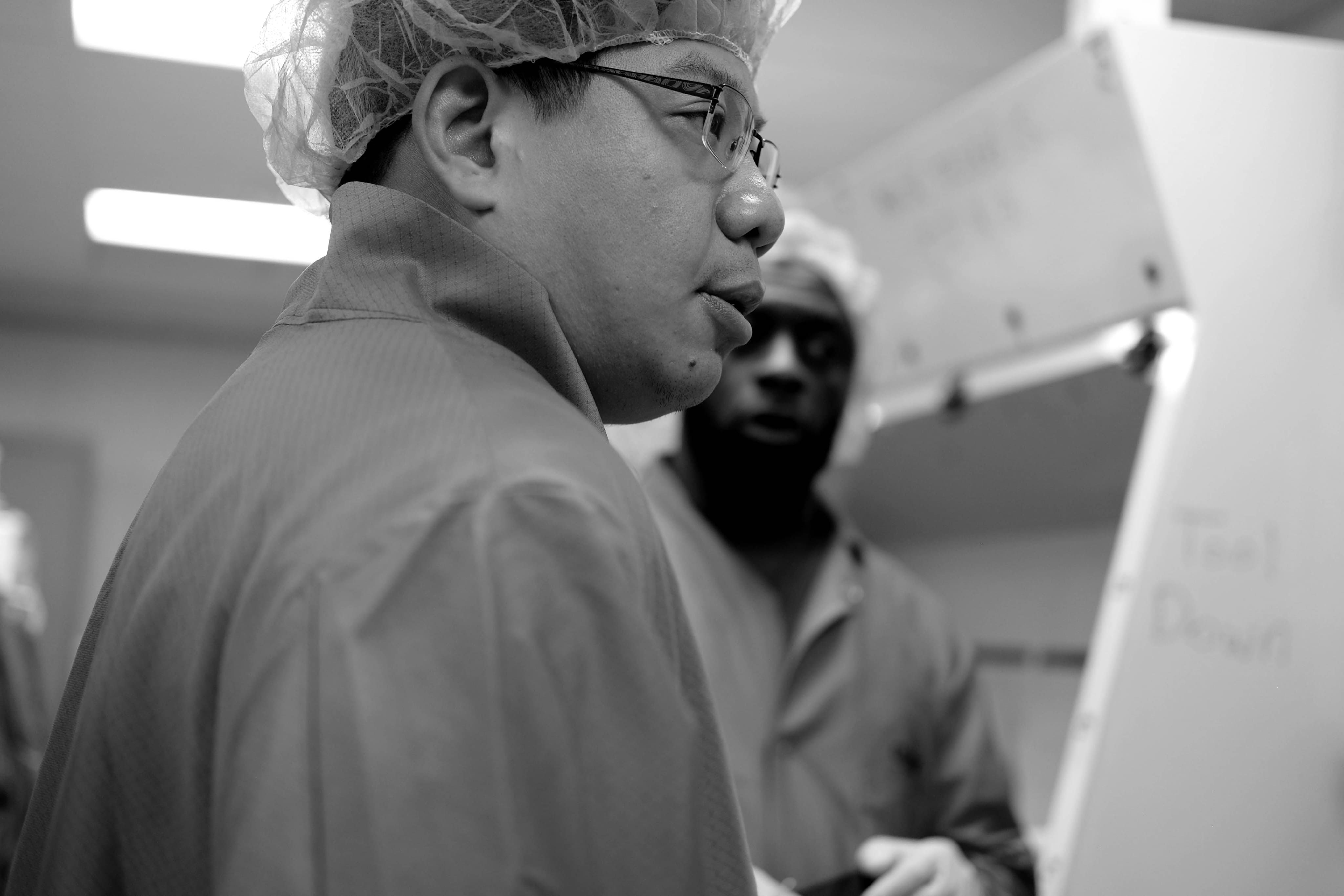 Two operators discuss technique outside the clean room.