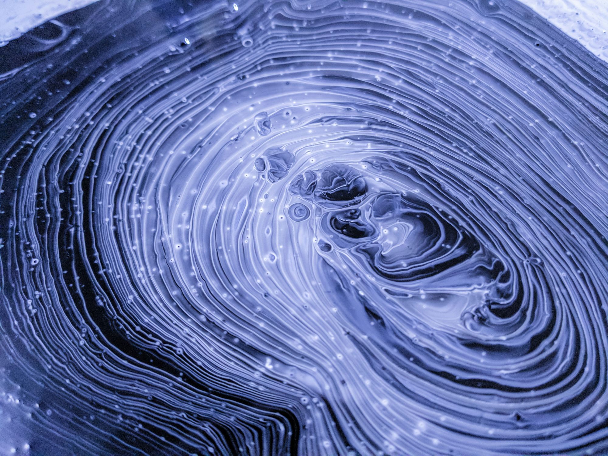 Rippling blue and white concentric waves, resembling a brain.