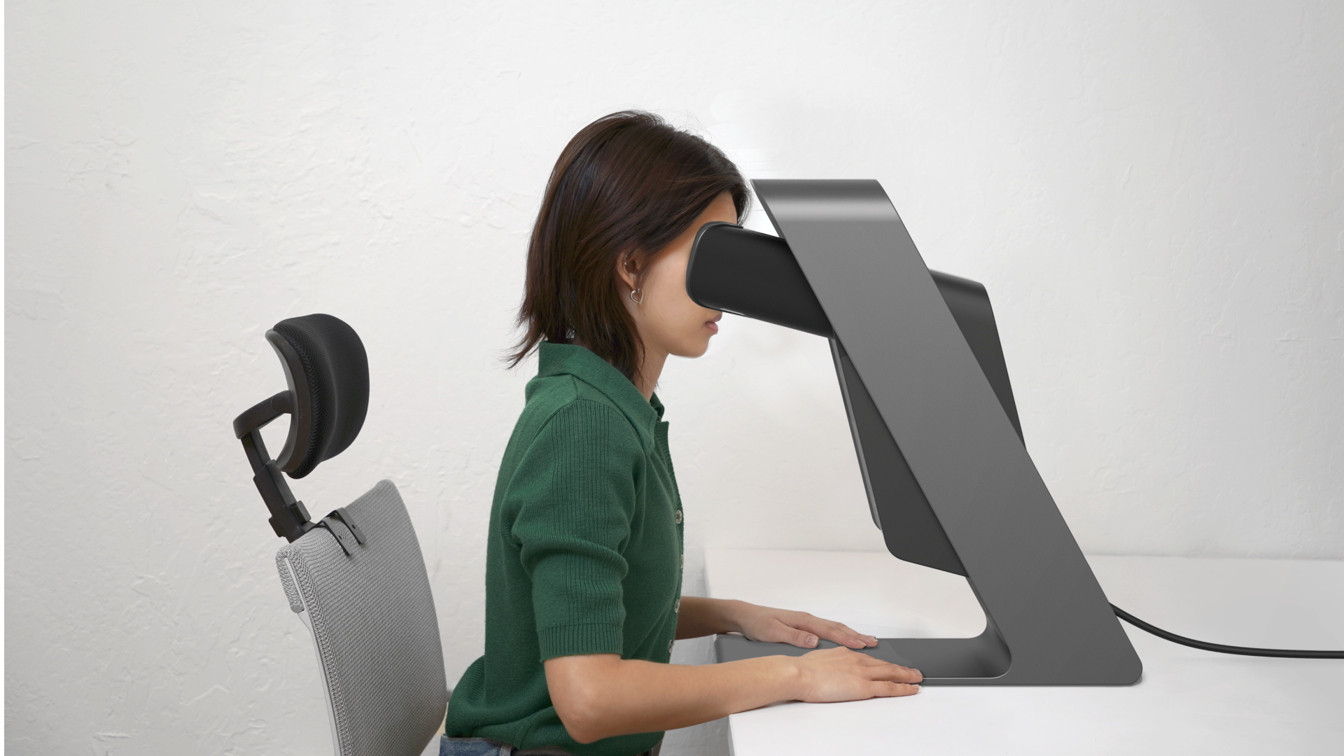 A render of a seated person looking into the Scope.