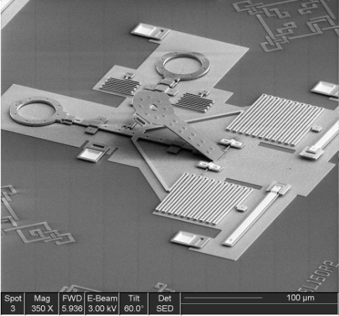 SEM photo of a microscopic catapult with metal coils to store potential energy